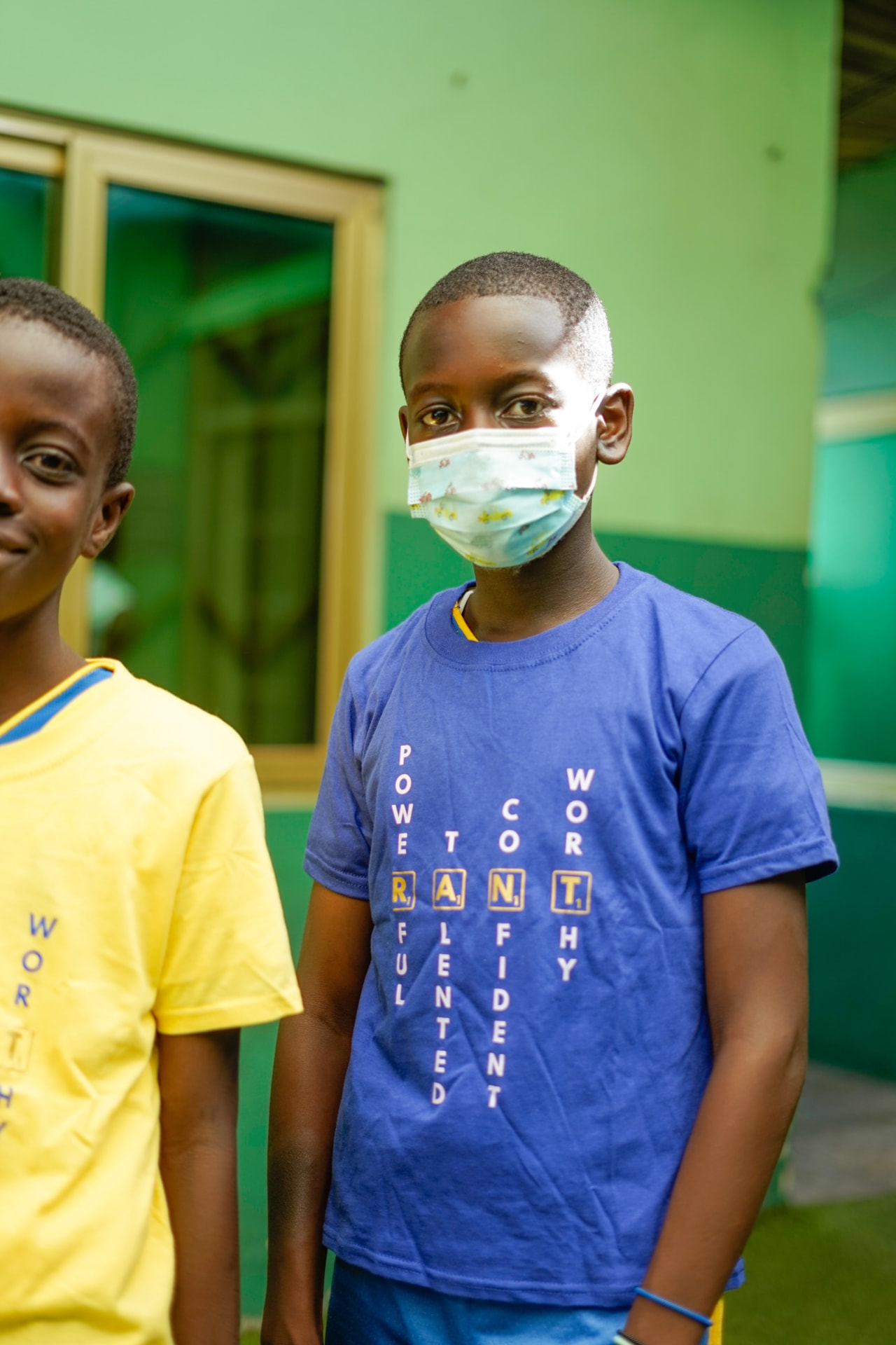 Two learners wearing RANT 'Powerful, Talented, Confident, Worthy' t-shirts