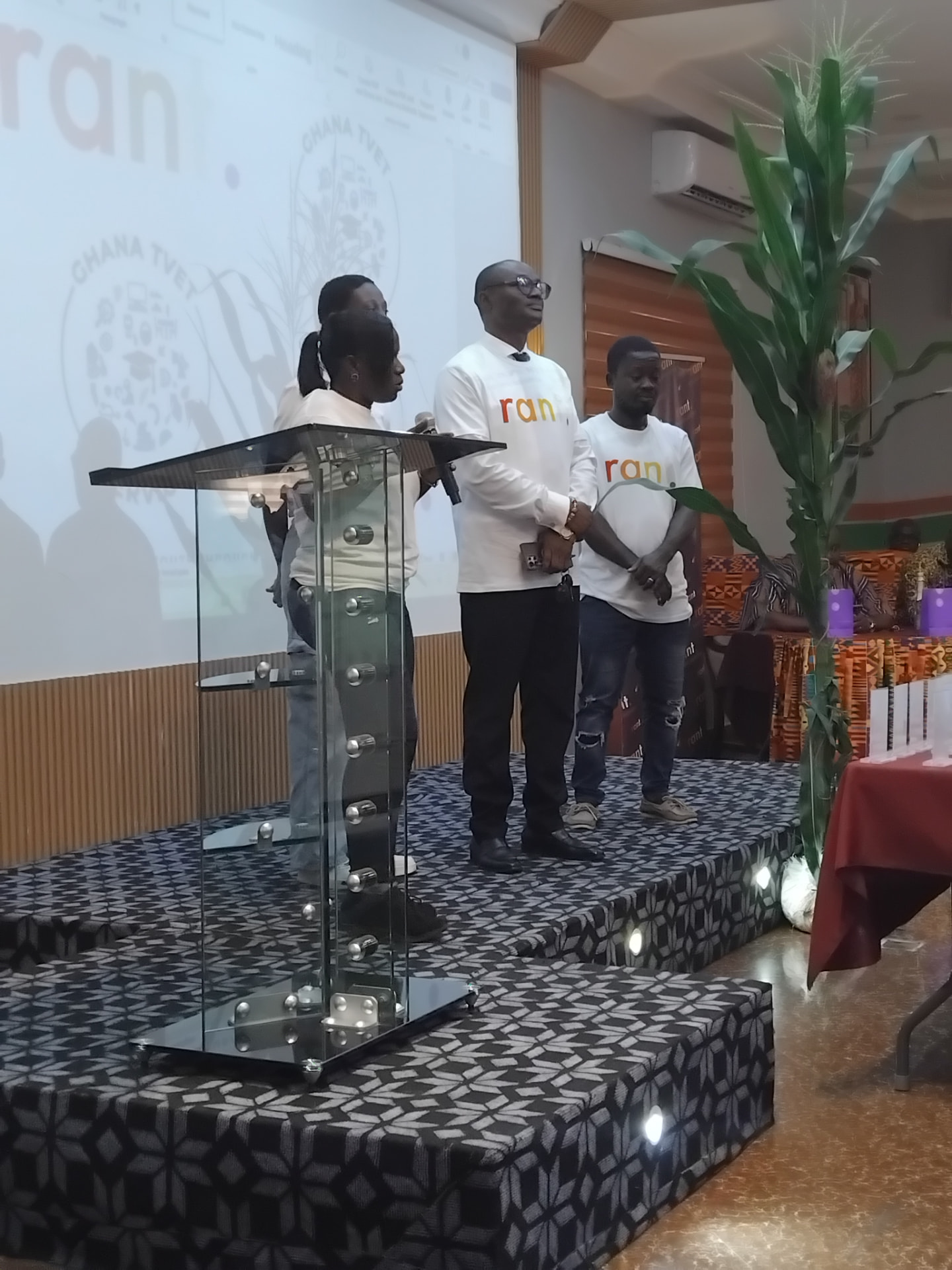 Members of the RANT delivery team in branded t-shirts on stage at the launch event