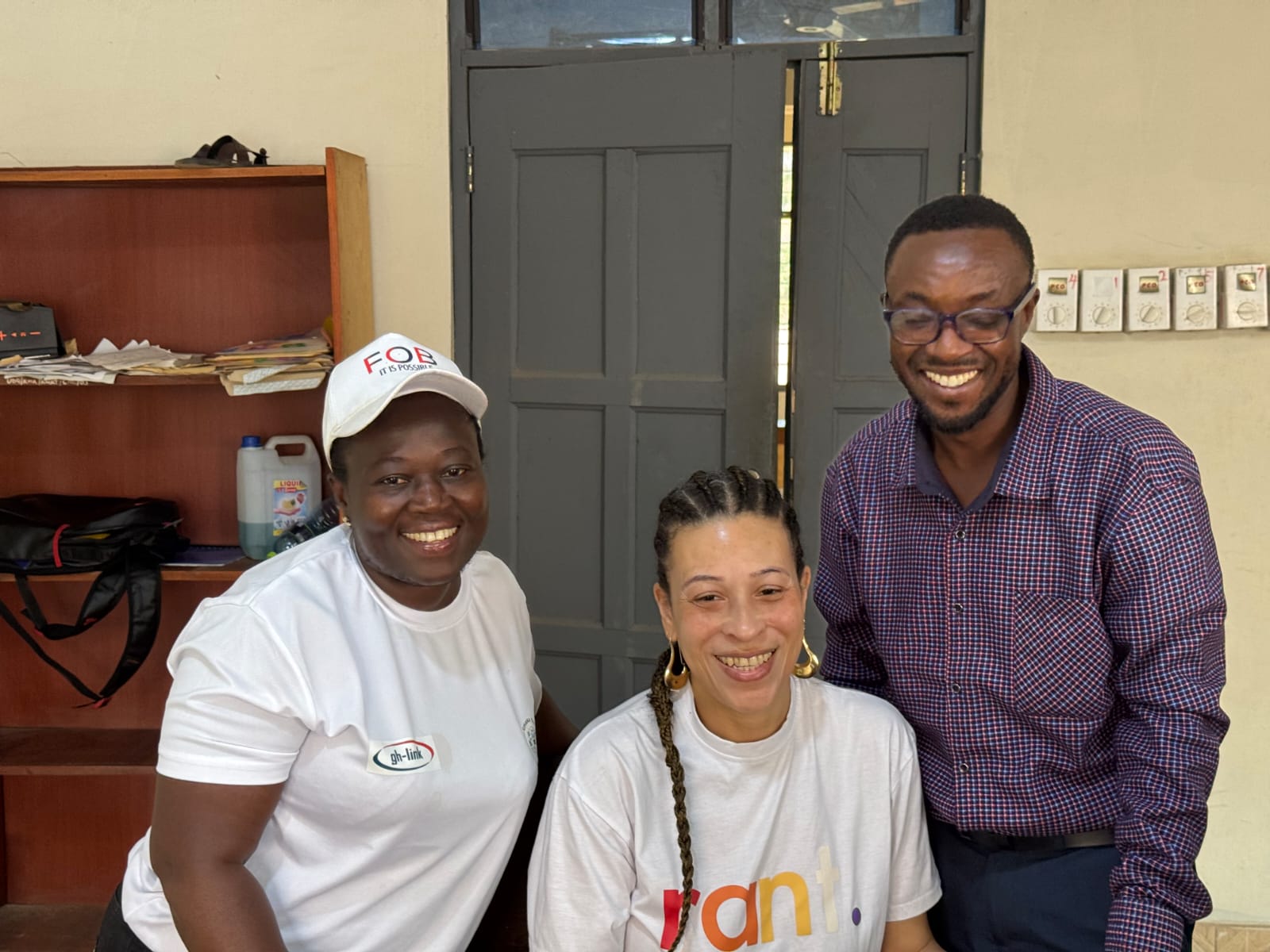 Three partners in RANT and gh-link t-shirts smiling together in an office
