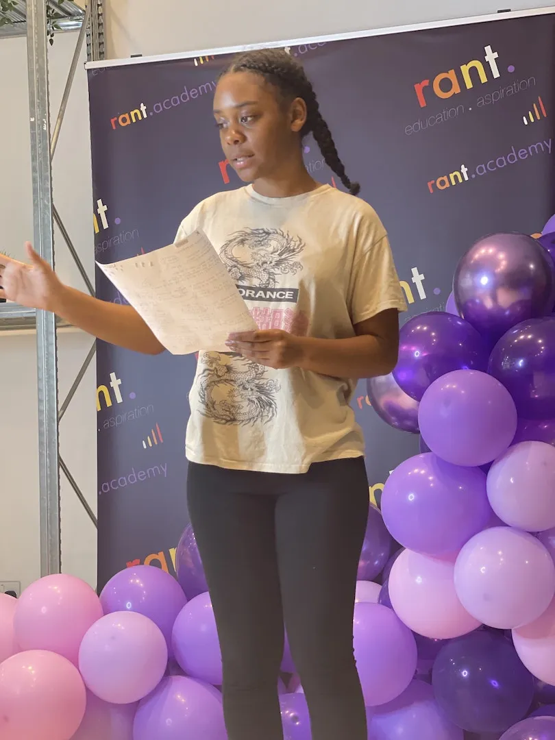 A young learner presenting her ideas on stage at a RANT Academy event in London