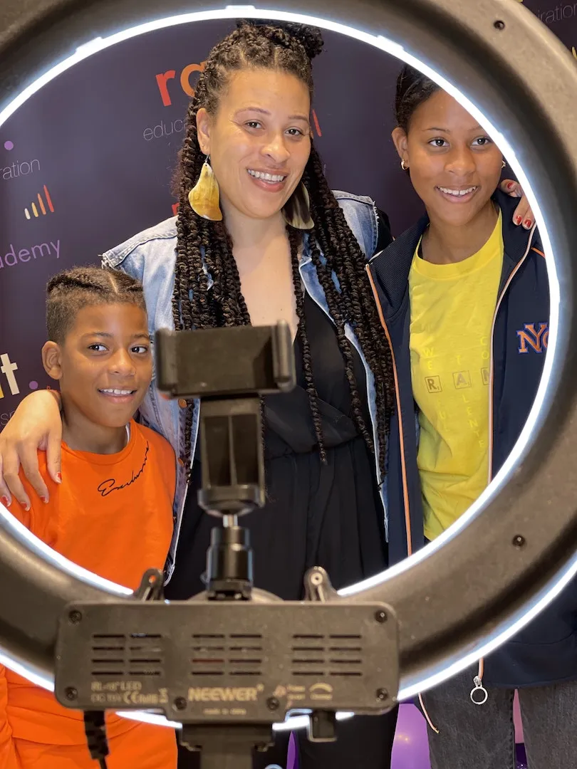 RANT Director Elizabeth Lambie with young learners behind a ring light at a London event